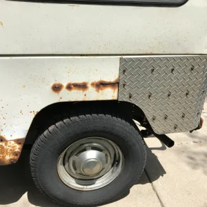 Driver's side rear bumper rust and diamond panel close up
